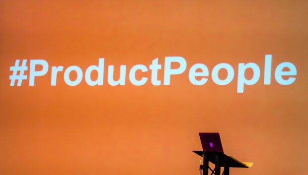Orange background with hash tag product people written in white. Copyright DWP Digital